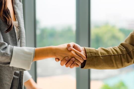 Business partnership handshake between Imperial Essence Trading LLC and a wholesale distribution client